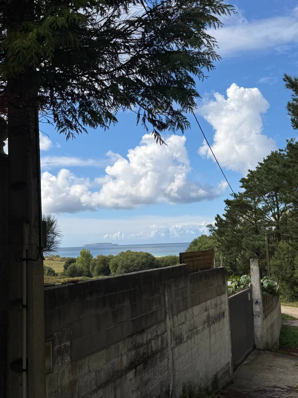 View of the sea from the side of the plot, next to the wall